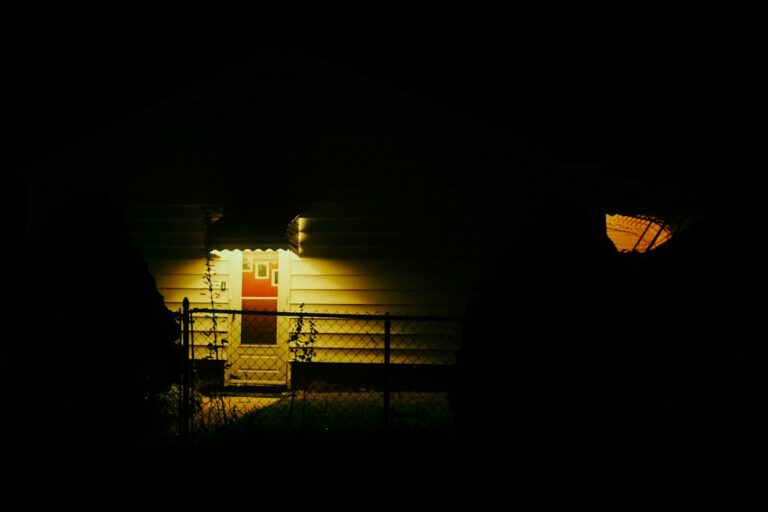 House front door lit by a porch light at night