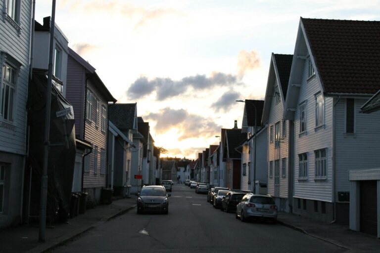 Residential street lined with houses at dusk