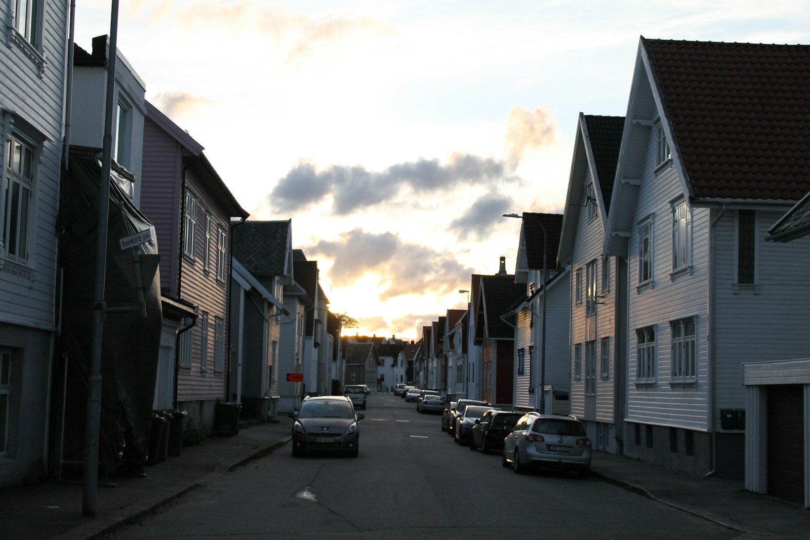 Residential street lined with houses at dusk